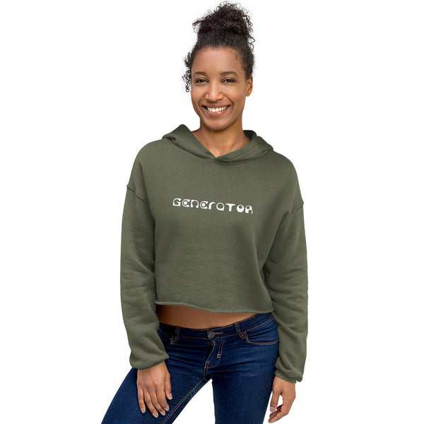 A smiling woman casually wears a military green cropped hoodie sweatshirt with the word Generator printed in white on the chest